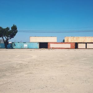 Scenic view of beach against clear blue sky