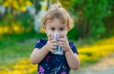 Portrait of cute girl drinking water