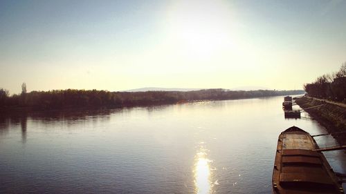 Scenic view of lake against sky at sunset