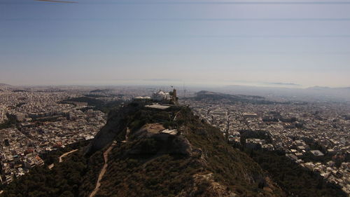 Aerial view of mount lycabettus by residential district against sky