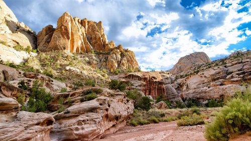 Rock formation against cloudy sky at capitol reef national park