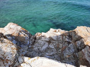 High angle view of rock formations by sea