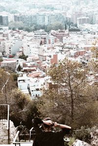 High angle view of buildings and trees in city