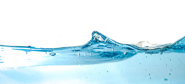 Close-up of water splashing against white background