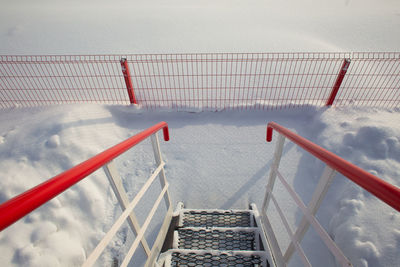 High angle view of ladder by swimming pool during winter