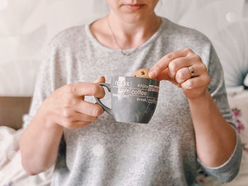 Midsection of woman having snack