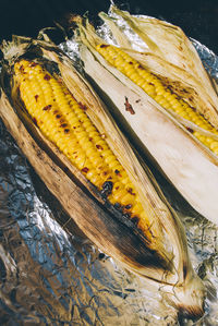 High angle view of corns on foil paper