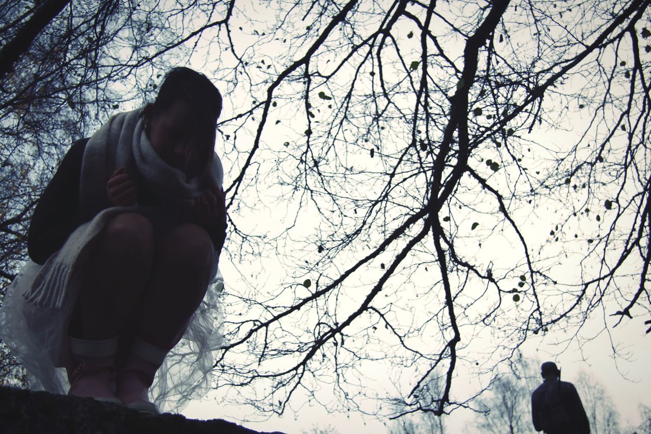 LOW ANGLE VIEW OF STATUE AGAINST BARE TREES