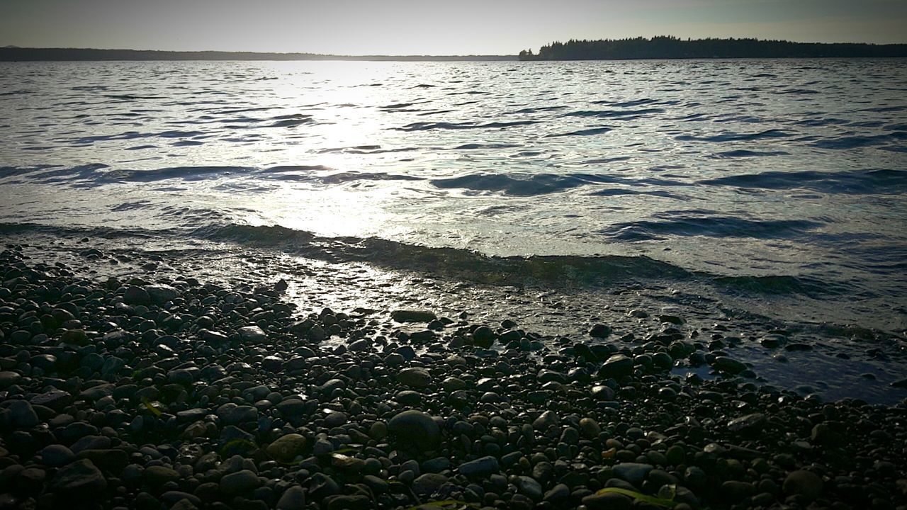 water, sea, tranquility, tranquil scene, scenics, beauty in nature, nature, shore, beach, rippled, high angle view, reflection, idyllic, outdoors, coastline, no people, sunlight, sunset, horizon over water, lake