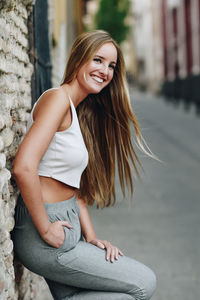 Portrait of a smiling young woman sitting outdoors