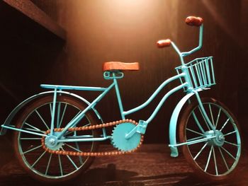 Bicycle parked against wall at night