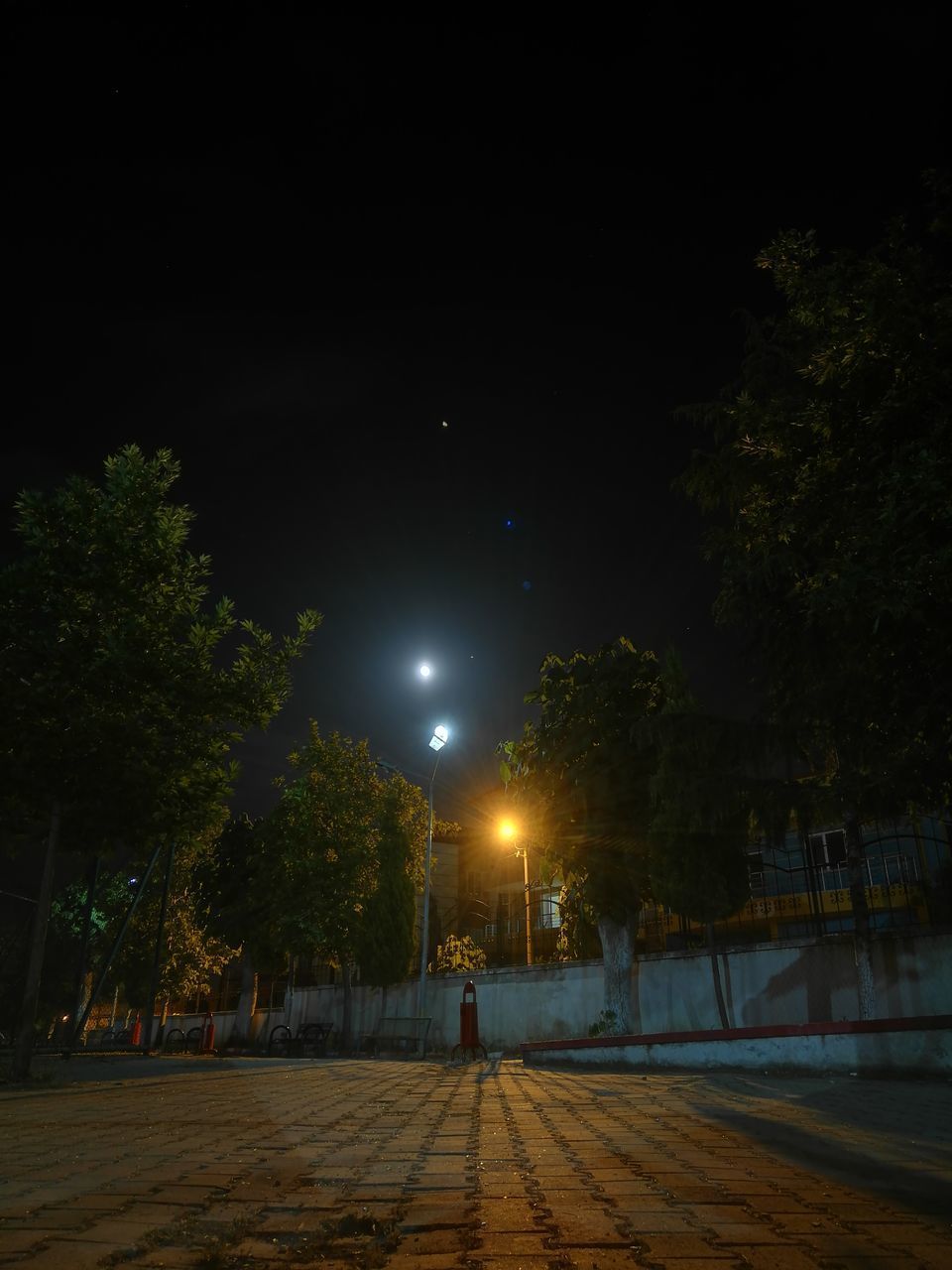 VIEW OF ILLUMINATED STREET AT NIGHT