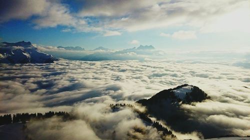 Scenic view of mountains against cloudy sky