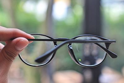 Close-up of hand holding eyeglasses