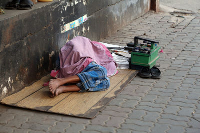 Man sleeping on footpath