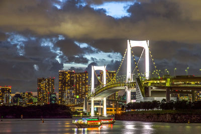 Rainbow bridge night view under twilight cloudy sky