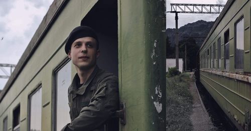 Young man at doorway of train