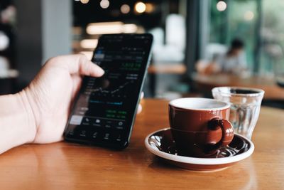 Midsection of coffee cup on table