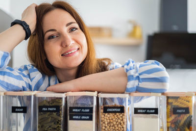 Portrait of smiling young woman sitting at home