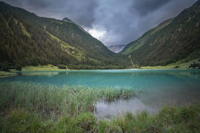 Scenic view of lake and mountains against sky