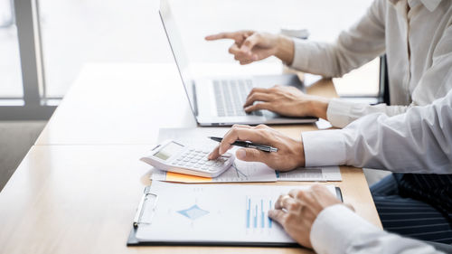 Low angle view of man using laptop on table