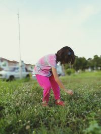 Girl standing on grass in park