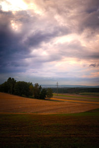 Scenic view of field against sky during sunset