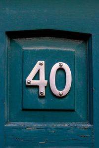 Close-up of text on blue door