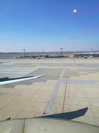 Airplane on airport runway against clear sky