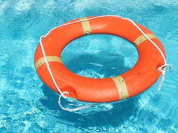High angle view of life belt floating on swimming pool