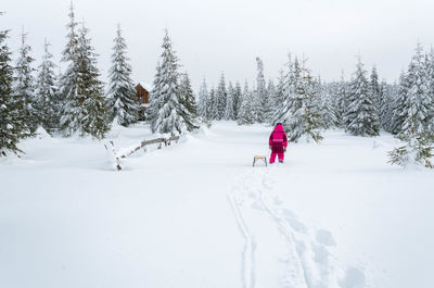 Man on snow covered land