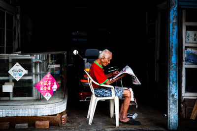 Man sitting on chair at home
