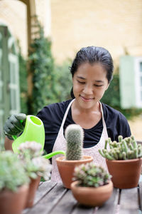 Woman watering succulent plant at workshop