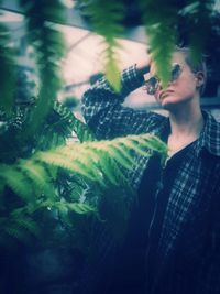 Young man holding plant