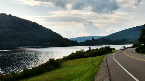 Scenic view of river with mountains in background