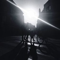 Silhouette of people in city