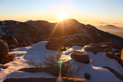 Scenic view of mountains against clear sky during sunset