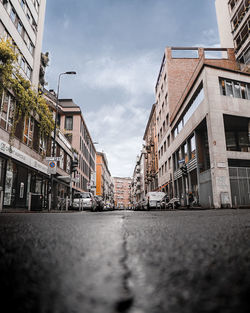 Surface level of street by buildings against sky