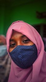 Portrait of young woman with pink face