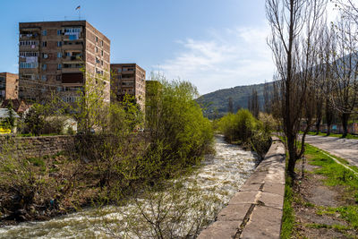 Footpath amidst buildings against sky