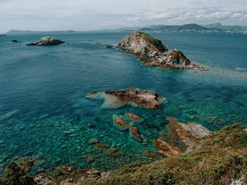 High angle view of rocks on shore against sky