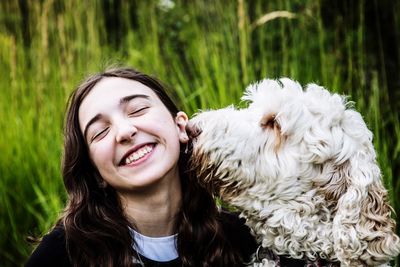 Smiling teenage girl with dog