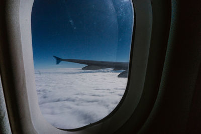Airplane wing seen through window