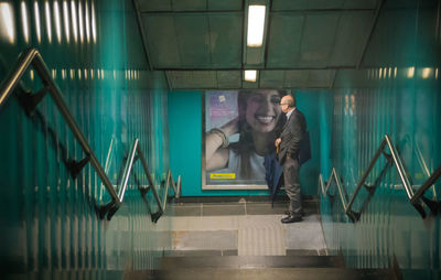 Portrait of smiling young woman on staircase