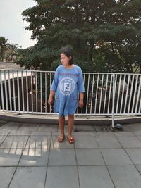 Full length of girl standing on railing