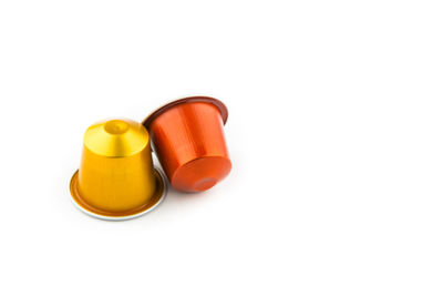 Close-up of yellow cup over white background