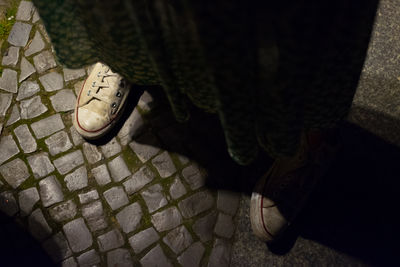 Low section of man standing on sidewalk