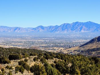 Scenic view of landscape and mountains against clear blue sky