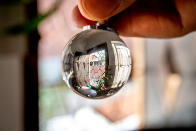 Close-up of hand holding glass hanging