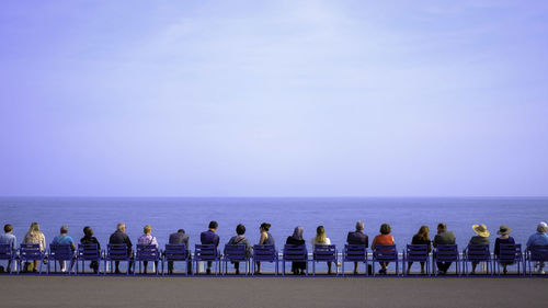 People on beach against clear sky